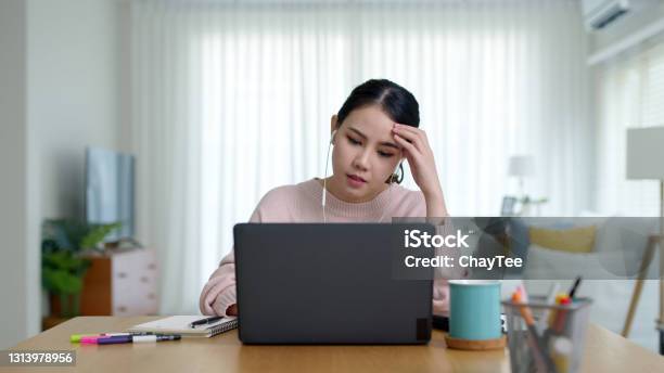 Young Asian Woman Employee Work From Home Using Computer Notebook Videocall Meeting Conference Angry Annoy With Low Poor Unreliable Internet Wifi Connection Problem Issue Outage Stock Photo - Download Image Now