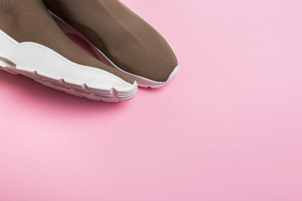 istock modern beige sneakers with white soles on pink background 1313979337