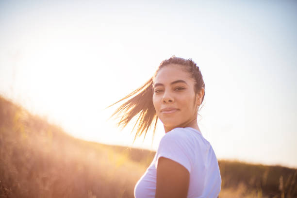 istock Young woman standing outside on a sunny day. 1313980480
