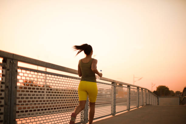 istock African woman jogging on the bridge. View from back. 1313980639