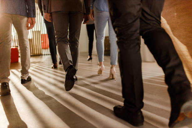 rear view of unrecognizable business people walking in a lobby. - business human foot shoe men imagens e fotografias de stock