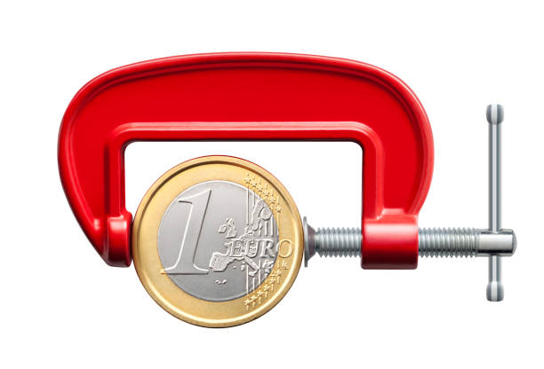 The euro crisis. Clamp compression tool with one euro coin Clamp compression tool with one euro coin isolated on white background. c clamp photos stock pictures, royalty-free photos & images