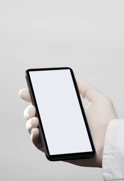 istock hands with gloves and phone with gray screen, white background 1313984019