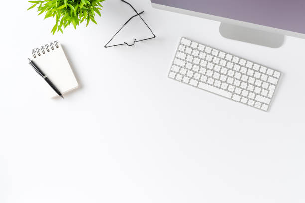 istock Overhead shot of computer with business accessories on white desktop. Modern workspace concept. Flat lay 1313987142