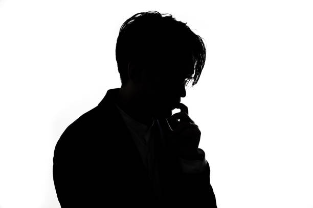 istock Silhouette of thinking businessman with white background. 1313990513