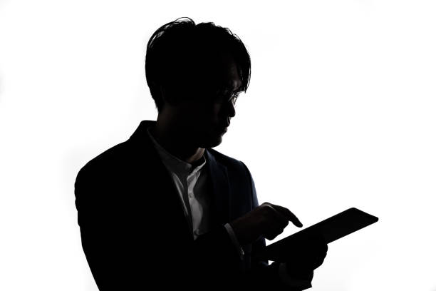 istock Silhouette of businessman use tablet isolate on  white background. 1313990523