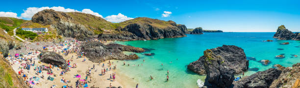 istock Summer holidaymaker crowd idyllic ocean beach Kynance Cove Cornwall panorama 1313990841
