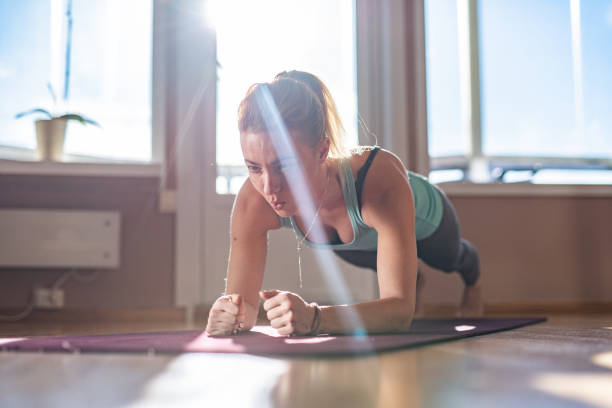 istock Woman in plank position at home 1313991744
