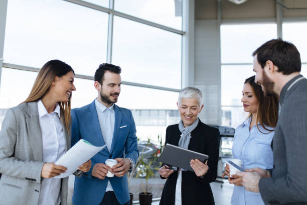 istock Corporate professionals having informal meeting using digital tablet 1313992082
