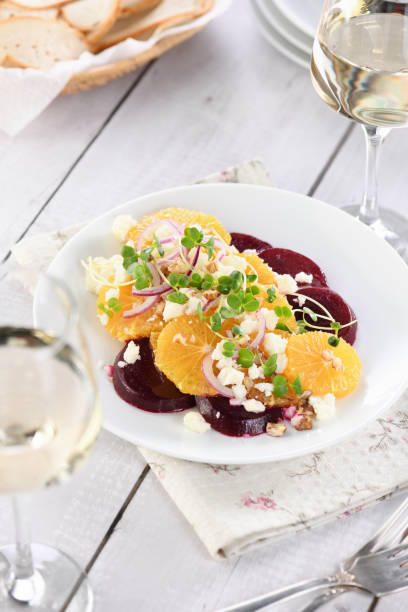 istock Orange salad with baked beetroot, goat cheese, microgreens and nuts. Perfect as a side dish or as a light lunch for a brunch or dinner. 1313994104