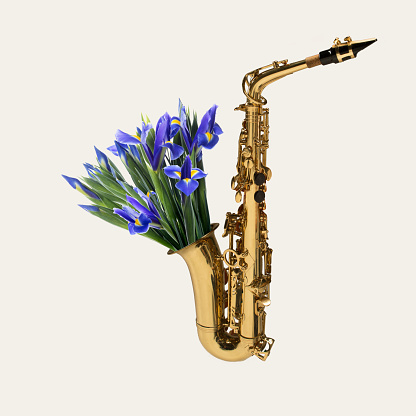 Saxophone with bouquet of blooming spring flowers on pastel background. Copy space for ad, text. Modern design. Conceptual, contemporary bright artcollage. Summertime, surrealism, fashionable.