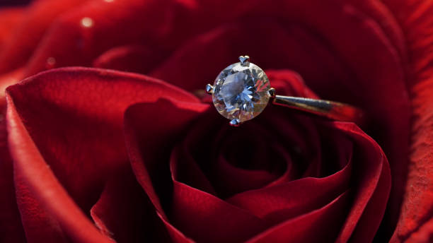 istock Wedding golden ring with a diamond on a rose. 1313994857