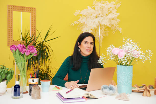 istock Beautiful middle age woman working in colorful cosy office, using portable laptop computer 1313997036