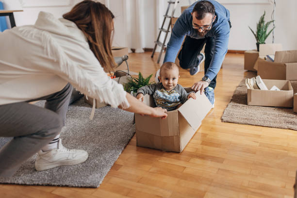 istock Couple playing with son in their new home 1313997290