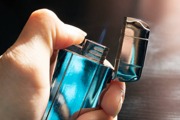istock Metal gas lighter in hand close up 1313997463