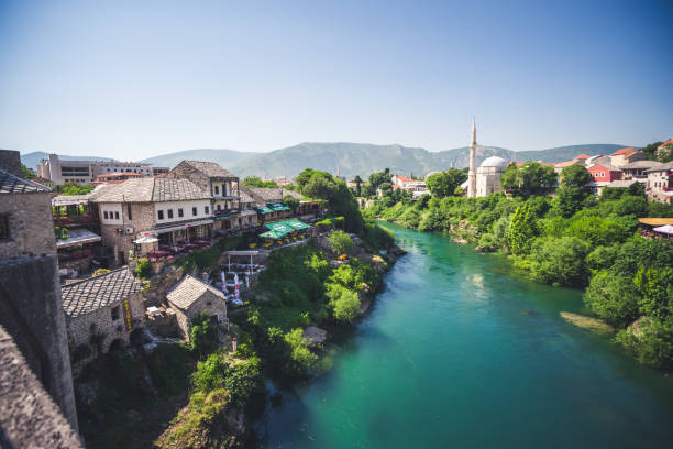Mostar, Bosnia and Herzegovina, 20.6.2019. Skyline of Mostar with the Mostarthe old  Bridge, houses and minarets, at n Bosnia and Herzegovina. Mostar, Bosnia and Herzegovina, 20.6.2019. Skyline of Mostar with the Mostarthe old  Bridge, houses and minarets, at n Bosnia and Herzegovina. stari most mostar stock pictures, royalty-free photos & images