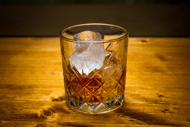 istock Glass of whisky with ice cubes 1313999036