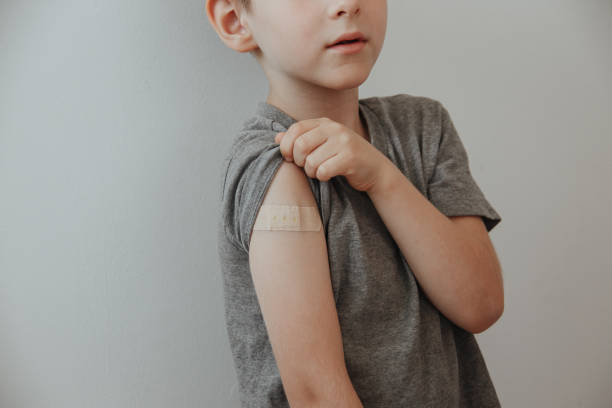 istock Vaccinated Boy Showing Arm After Covid-19 Vaccine Injection 1313999047