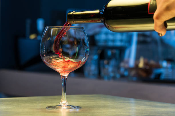 istock Pouring red wine into glass 1313999062