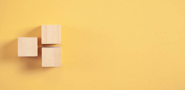 istock Wooden cubes on yellow background. 1313999125