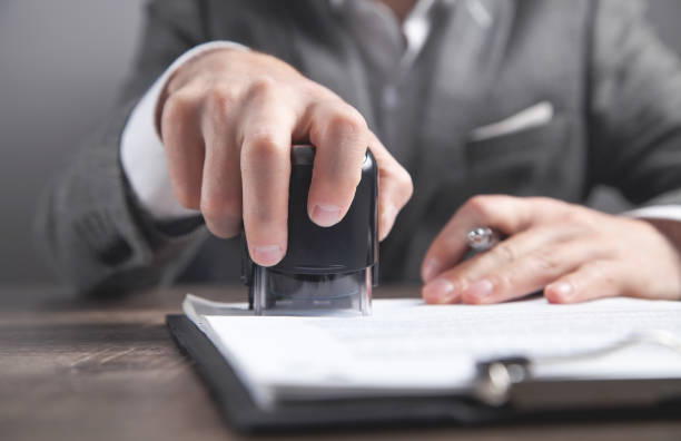 istock Businessman puts a stamp on the documents in the office. 1313999156
