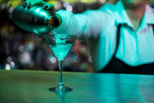 istock Bartender pouring cocktail into glass 1313999172