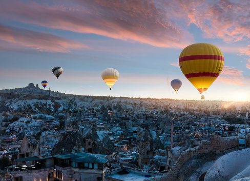 Scenic summer landscape with hot air balloon, forest and mountains.