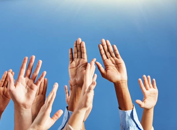 istock Many hands raised to heaven, praying or worshiping 1314001350