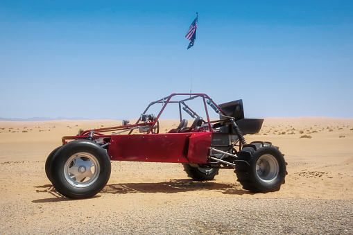 A dune buggy on a desert road.