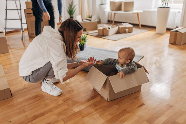 istock Mother playing with son in their new home 1314003885