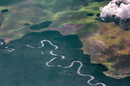 Aerial view of the congo basin,where a meandering river winds through tropical rainforest. republic account,west africa