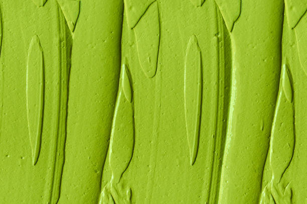 istock Green cosmetic clay (cucumber facial mask, avocado face cream, matcha body wrap) texture close up, selective focus. Abstract background with brush strokes. 1314007186