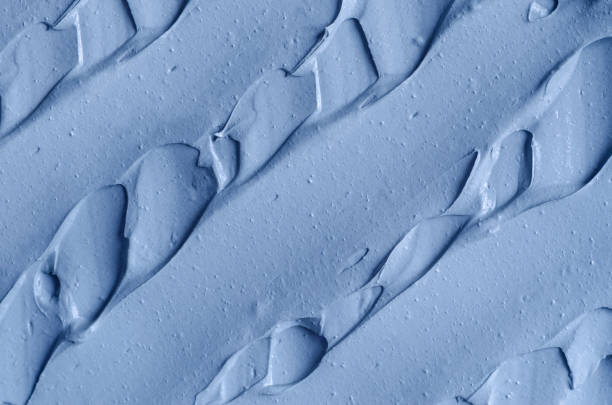 istock Light blue facial clay (mask, face cream, body wrap) texture close up, selective focus. Abstract background with brush strokes. 1314007237