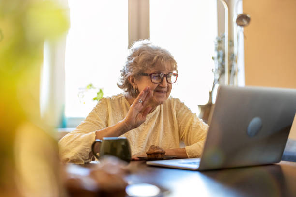 istock Happy senior woman using laptop at home 1314007943