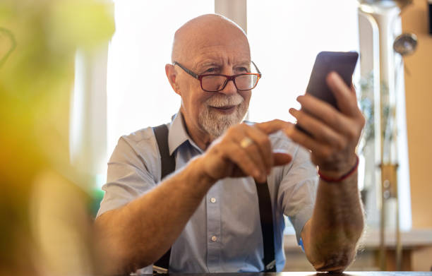 istock Shot of a senior man using a mobile phone at home 1314008018