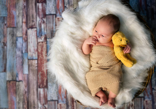 istock Newborn baby hugging  teddy beer 1314008704
