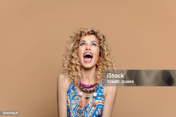 Excited Woman In Boho Style Outfit Against Brown Background Stock Photo - Download Image Now