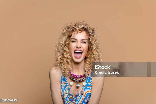 Excited Woman In Boho Style Outfit Against Brown Background Stock Photo - Download Image Now