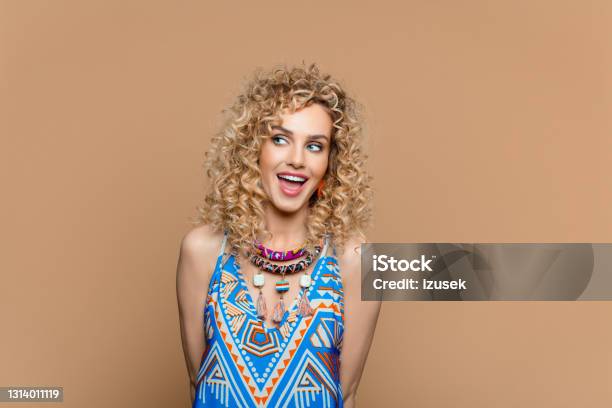 Surprised Woman In Boho Style Outfit Against Brown Background Stock Photo - Download Image Now