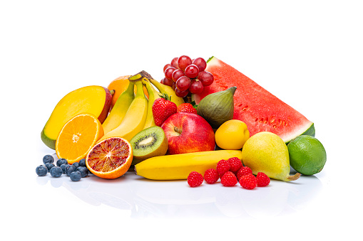 Close up of healthy fresh fruits heap isolated on white background. The composition includes banana, apple, fig, orange, blueberry, grape, pear, kiwi, watermelon, strawberry among others. High resolution 42Mp studio digital capture taken with Sony A7rII and Sony FE 90mm f2.8 macro G OSS lens