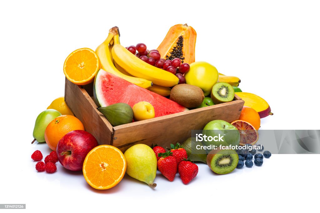 Multicolored fruits in a crate on white background Healthy fresh fruits in a wooden crate isolated on white background. The composition includes mango, banana, apple, fig, orange, kiwi, blueberry, lime, grape, strawberry, pear, peach, papaya, watermelon among others. High resolution 42Mp studio digital capture taken with Sony A7rII and Sony FE 90mm f2.8 macro G OSS lens Fruit Stock Photo