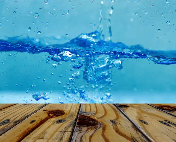 Photo of Empty wooden table on underwater background.