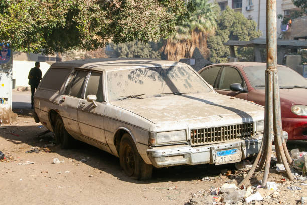 Old, weathered pickup truck with rusted parts and faded paint, parked outside