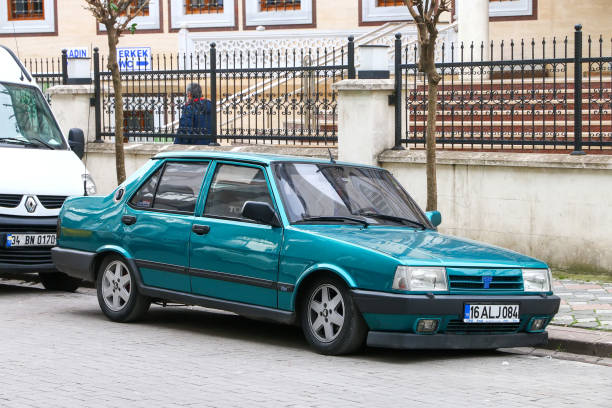 Tofas Dogan Istanbul, Turkey - February 11, 2021: Green saloon car Tofas Dogan in the city street. saloon car stock pictures, royalty-free photos & images