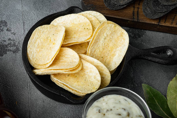 istock Salty potato chips snack , with dipping sauces , on gray stone background, top view flat lay 1314014289
