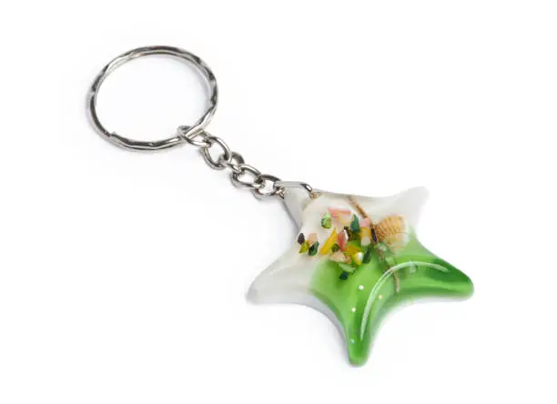 Epoxy resin key ring in a star shape with sea shells isolated on a white background with clipping path