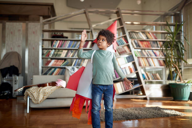 istock Cute afro american kid playing with paper rocket 1314017284