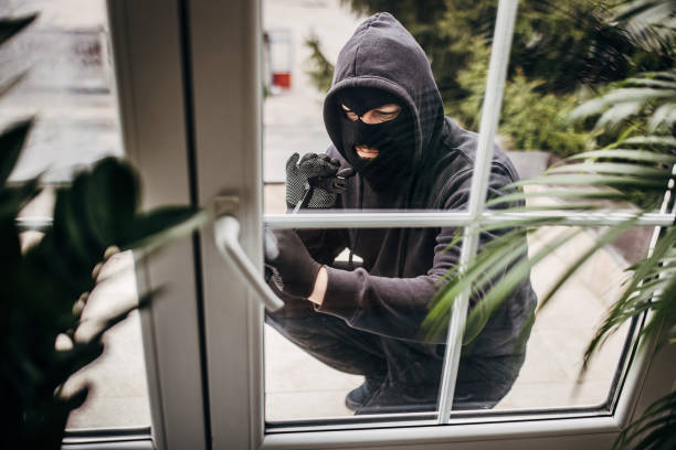 istock Criminal trying to brake in house 1314018591