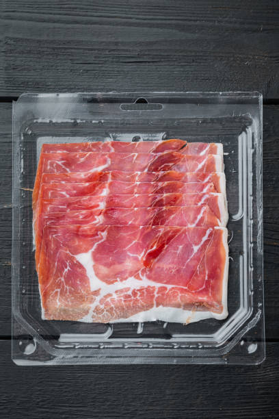 istock Parma ham, on black wooden background, flat lay 1314019349