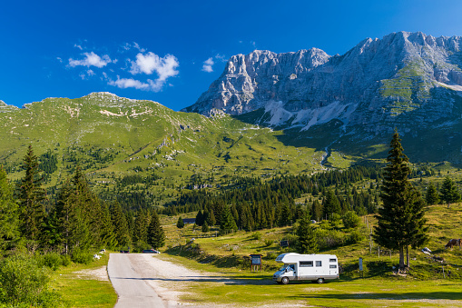 Caravan in summer mountain landscape, Alps, Italy